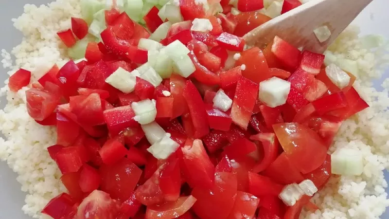 2. Takto pripravený kuskus necháme 10 minút prikrytý, aby napučal. Pripravíme si čerstvú zeleninu. V našom recepte sme zvolili čerstvé paradajky, červenú papriku a uhorku. Zeleninu nakrájame na malé kocky alebo rezance.