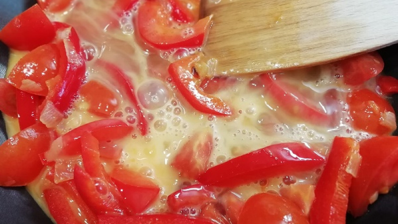 4. Ak zvolíme klasické paradajky, po 3 minútach restovania paprík ich tiež pridáme. Keď použijeme cherry paradajky, pridávame ich až ku koncu, Samotné papriky restujeme 10 minút.