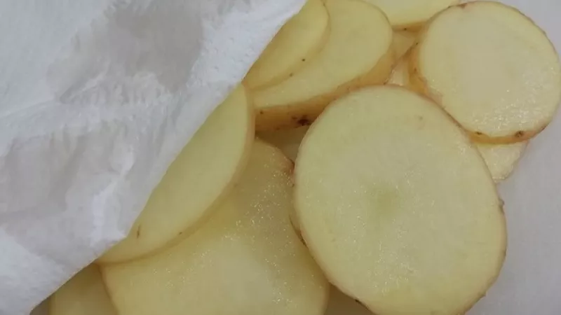 2. Osušené zemiaky nakrájame na tenké plátky, papierovým obrúskom ich zbavíme škrobu. Je dôležité, aby boli suché.